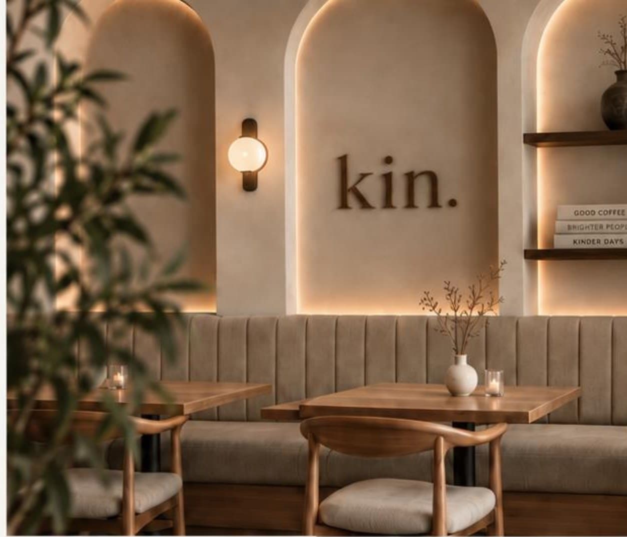 Lit arches over the long banquette, with the kin lettering on the wall